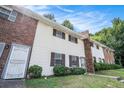 A tidy row of townhouses with white exteriors, brick accents, and well-maintained lawns and windows at 6354 Shannon Pkwy # 30C, Union City, GA 30291