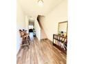 Welcoming entryway features wood-look flooring and staircase at 6408 Kennonbriar Ct, Lithonia, GA 30058