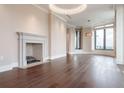 Bright living room featuring a cozy fireplace, hardwood floors, and large windows with city views at 3376 Peachtree Ne Rd # 35A, Atlanta, GA 30326