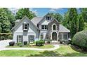 Charming two-story home with stone accents, manicured lawn, and inviting entryway at 7920 Tintern Trce, Duluth, GA 30097