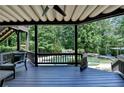 Relaxing covered patio with view of pool and waterfall feature at 7920 Tintern Trce, Duluth, GA 30097