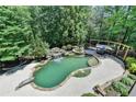Aerial view of a backyard pool and spa with lush landscaping at 7920 Tintern Trce, Duluth, GA 30097