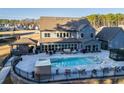 Beautiful backyard with a pool, hot tub, covered patio, and ample seating for entertaining at 149 Avalon Way, Sharpsburg, GA 30277