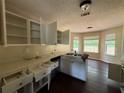 Bright kitchen with white cabinets, double sink, and abundant natural light from multiple windows at 160 Goldleaf Dr, Hampton, GA 30228