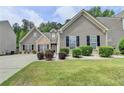 Well-manicured front lawn and carefully placed landscaping enhances the charm of this two-story home at 2842 Sedgeview Ln, Buford, GA 30519