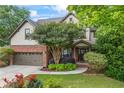 Charming two-story home with a brick and neutral siding exterior, attached two-car garage, and mature landscaping at 414 Silver Top Dr, Grayson, GA 30017