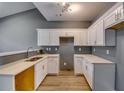 Modern kitchen with white cabinets, quartz countertops, and stainless steel sink at 6269 Colonial Vw, Fairburn, GA 30213