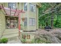 Inviting front porch with stone accents, wood railings, and decorative plants, creating a cozy entry at 265 Lee River Cv, Suwanee, GA 30024