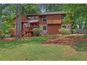 Well-maintained two-story house with a combination wood and stone exterior and landscaped yard at 3007 Manning Dr, Marietta, GA 30062