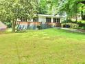Classic home with a spacious green lawn and mature trees, ideal for outdoor enjoyment at 3086 Lone Oak Sw Ave, Atlanta, GA 30354