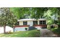 Inviting one-story home with lush trees, manicured lawn, and convenient driveway at 3086 Lone Oak Sw Ave, Atlanta, GA 30354