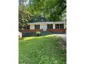 Traditional single-story home with dark shutters, brick accents, and a landscaped front yard at 3086 Lone Oak Sw Ave, Atlanta, GA 30354