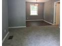 Open-concept living room featuring neutral paint colors and a dining area with modern lighting at 3086 Lone Oak Sw Ave, Atlanta, GA 30354