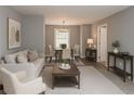 Nicely decorated living room featuring a comfortable sofa, chair, and an adjacent dining area at 3086 Lone Oak Sw Ave, Atlanta, GA 30354