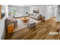 Living room featuring neutral tones, hardwood floors, and large windows providing natural light at 355 Marietta Hwy, Roswell, GA 30075