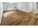 Open living room area featuring hardwood floors and windows allowing lots of natural light at 355 Marietta Hwy, Roswell, GA 30075