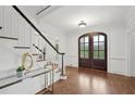 Elegant foyer with hardwood floors and a beautiful dark front door and staircase at 230 Summerhouse Ln, Atlanta, GA 30350