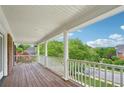 Spacious covered porch with wood flooring and views of the neighborhood at 230 Summerhouse Ln, Atlanta, GA 30350