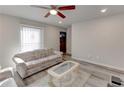 Bright living room with neutral walls, wood-look floors, ceiling fan, and large window at 3252 Abbeywood Dr, Decatur, GA 30034