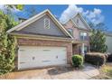 Lovely brick home with a two-car garage, manicured bushes, and a well-kept lawn at 4889 Arbor View Nw Pkwy, Acworth, GA 30101