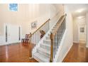 Bright, inviting foyer with hardwood floors, a staircase, and a view to the front door at 4889 Arbor View Nw Pkwy, Acworth, GA 30101