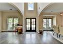 Elegant foyer with high ceilings, beautiful hardwood floors, and large windows at 9440 Knollcrest Blvd, Alpharetta, GA 30022