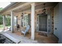 Covered front porch with decorative columns and comfortable seating area at 176 Oakland Way, Dallas, GA 30157