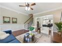 Bright living room with hardwood floors, ceiling fan, and stylish furniture arrangement at 2828 Broughton Se Ln, Atlanta, GA 30339