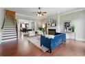 Inviting living room featuring hardwood floors, fireplace, and staircase with stylish furniture at 2828 Broughton Se Ln, Atlanta, GA 30339