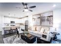 A modern living space with an open-concept layout, stylish decor, and a ceiling fan at 3351 Orwell Way # 2305, Cumming, GA 30041