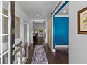 Welcoming entryway with hardwood floors, stylish decor, and a view into the living spaces at 5178 Stefan Ridge Way, Buford, GA 30519