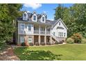 Charming two-story home with a covered front porch,dormer windows, and a well-maintained front yard at 5178 Stefan Ridge Way, Buford, GA 30519