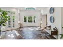 Grand foyer with stone floors, high ceilings, natural light from a skylight and views to the outdoors at 5251 Powers Ferry Rd, Atlanta, GA 30327