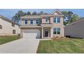 Charming two-story brick home features a covered entryway and a two-car garage at 623 Leafy Branch Way, Mcdonough, GA 30253