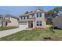 Lovely two-story brick home with an attached two-car garage and green lawn at 623 Leafy Branch Way, Mcdonough, GA 30253
