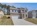 Attractive two-story brick home offers a spacious driveway and manicured front yard at 623 Leafy Branch Way, Mcdonough, GA 30253