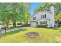 Exterior of a two-story home with a large front yard and driveway, surrounded by lush greenery at 912 Third St, Stone Mountain, GA 30083