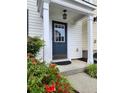 Inviting entrance with a blue front door, white trim, and colorful flowers, providing a warm welcome at 10900 Wittenridge Dr # H8, Alpharetta, GA 30022