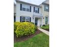 Charming home with well-maintained landscaping featuring vibrant greenery and a cozy front porch at 10900 Wittenridge Dr # H8, Alpharetta, GA 30022