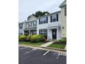 Inviting home featuring classic shutters, a cozy front porch, and easy parking access at 10900 Wittenridge Dr # H8, Alpharetta, GA 30022