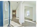 Inviting entryway features wood-look floors, neutral walls, and an open floor plan at 11850 Rizvan Pl, Covington, GA 30014