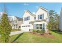 Delightful two-story home features a well-manicured lawn and a concrete driveway for easy parking at 11850 Rizvan Pl, Covington, GA 30014