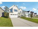 Beautiful single-Gathering home with a concrete driveway, lovely lawn, and multiple neighboring homes in the background at 11850 Rizvan Pl, Covington, GA 30014