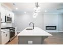 Bright kitchen with island, pendant lighting, stainless appliances, and an adjacent living area at 1624 Ruskin Way, Marietta, GA 30062