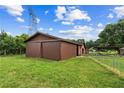 Outbuilding with large sliding doors, offering ample storage space or workshop potential at 3105 Hamilton Mill Rd, Buford, GA 30519