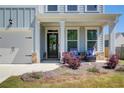 Inviting front porch with seating, decorative wreath, and manicured landscaping at 42 Citrine Way, Acworth, GA 30101