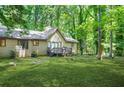 Backyard view of home with a small deck perfect for outdoor enjoyment and serene nature views at 5837 Fox Run, Rex, GA 30273