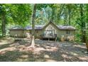 Backyard view of home with a small deck perfect for outdoor enjoyment and serene nature views at 5837 Fox Run, Rex, GA 30273