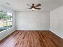 Bright living room featuring wood-look flooring and large windows at 105 Odyssey Turn, Conyers, GA 30012