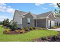Beautiful gray brick home exterior showcasing manicured lawn and complementing neutral trim at 244 Nesta Grove, Locust Grove, GA 30248